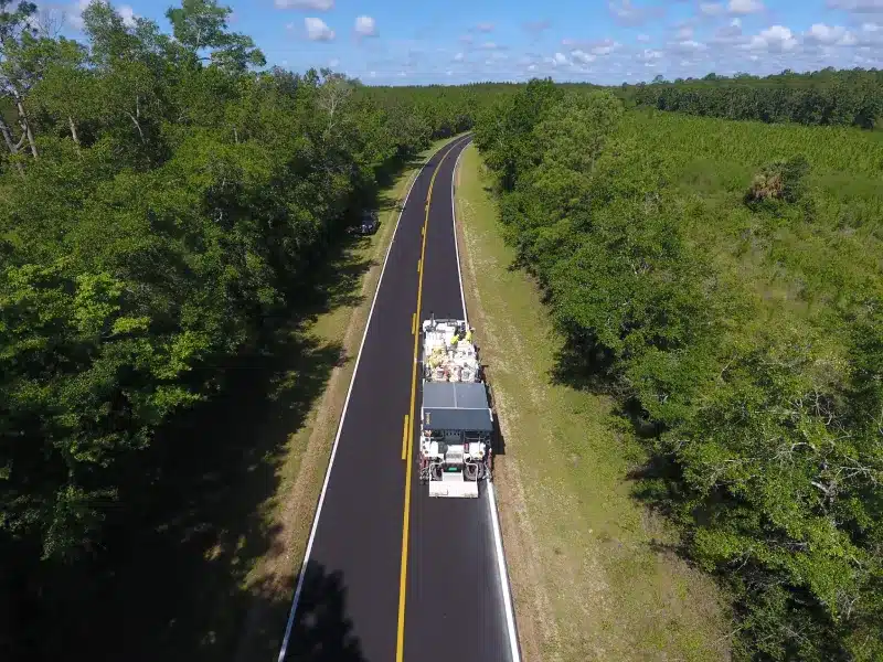 Aerial view of two-lane highway through wooded area
